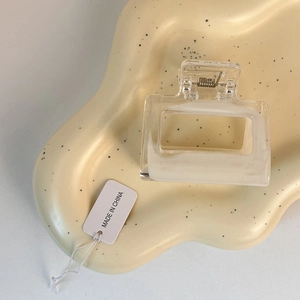 Close-up of a matte transparent square hair claw clip with a durable metal spring detail