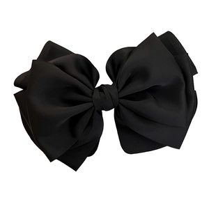 Elegant large black silk satin bow hair clip with layered ribbon design on white background
