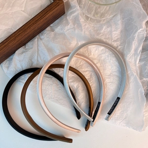 Detailed view of handmade satin headbands in black, coffee, champagne and silver colors
