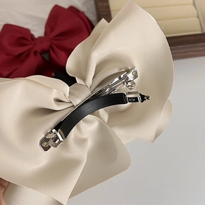 Elegant large cream satin bow hair clip with a durable metal spring closure for women