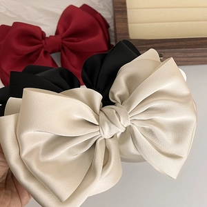 Elegant French satin bow hair clips in red black and beige colors with silky fabric texture
