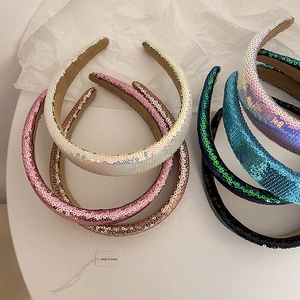 Macro shot of colorful sequin padded headbands showing glossy texture and various shades