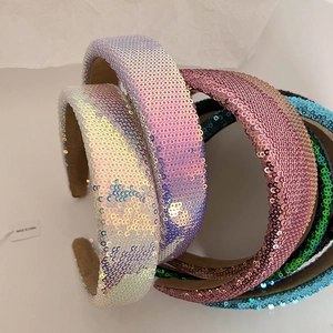 Close-up of sparkling sequin headbands in multiple colors with non-slip velvet lining detail