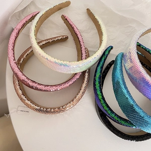 Close-up of sparkling multi-color sequin headbands with soft brown velvet anti-slip lining