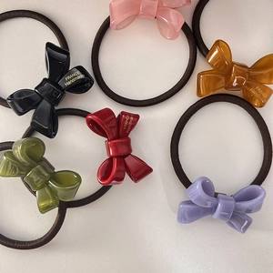 Set of six colorful bow hair ties featuring France Handmade print in assorted elegant shades