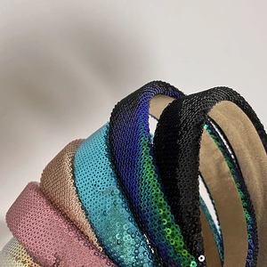 Detailed macro view of multi-colored sequin headbands with sparkling textures and soft lining