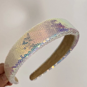 Macro detail of wide iridescent sequin headband with anti-slip inner fabric lining