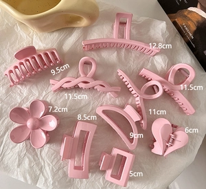 Detailed view of pink shark hair clips in various sizes from 5cm to 12.8cm