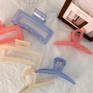 Set of large 13cm jelly hair claws in blue pink and cream on a decorative white background