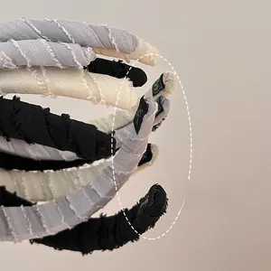 Detail showing distressed fabric texture and handmade label on soft sponge headbands