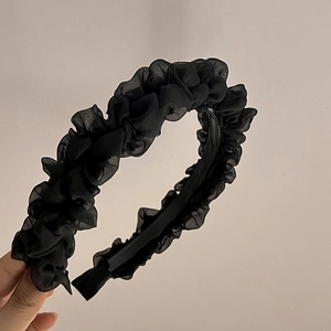 Detail view of black organza pleated headband showing soft mesh texture and inner anti-slip teeth