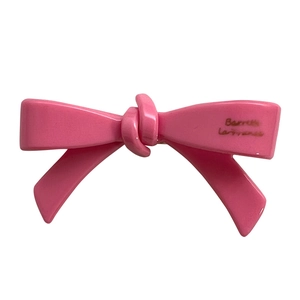 Barrette à cheveux nœud rose vif avec logo doré Barrette la France sur fond blanc