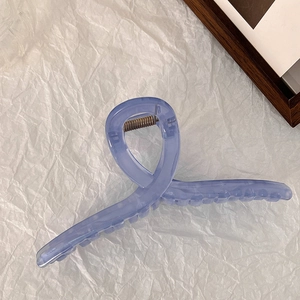 Detailed view of translucent blue-purple twist hair claw clip with a glossy finish