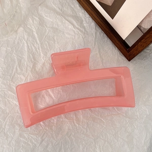 Macro detail of 13cm pink jelly hair claw clip with strong metal spring and teeth