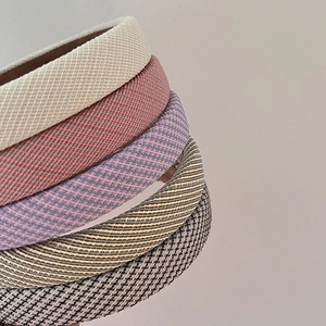 Close-up of five fabric headbands showing textures like honeycomb, plaid, and houndstooth