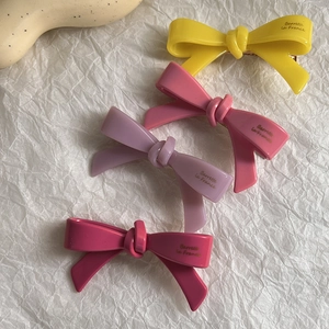 Lot de quatre barrettes à cheveux nœuds colorés en jaune, rose, violet et magenta