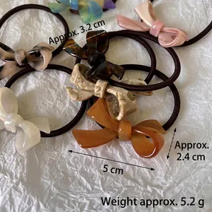 French style acetate bow hair ties in tortoise marble and pearl white finishes
