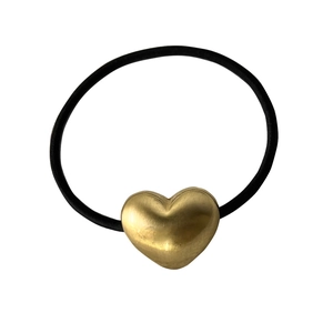 Vintage brushed metal heart hair tie with black elastic rope on white background