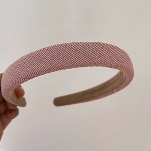 Detail shot of the pink woven pattern fabric and anti-slip lining on the padded headband
