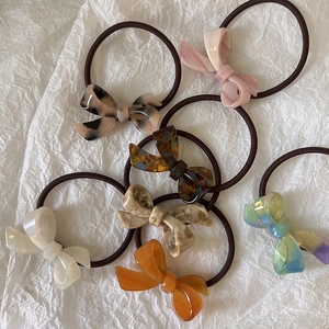 Set of 6 colorful acetate bow hair ties with elastic bands in leopard and pastel patterns