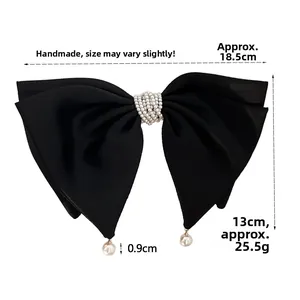 Detail showing dimensions of oversized black satin bow hair clip with pearl beads