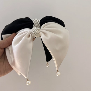 Elegant satin bow hair clip set with pearl wrap detail in black and white finish