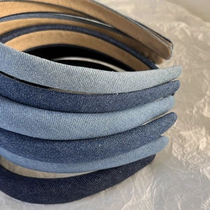 Close-up of denim textured headbands in light, medium, and dark blue with non-slip lining