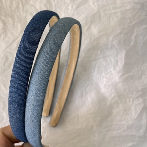 Detail shot of blue denim headbands showing woven fabric texture and non-slip lining