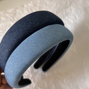 Detailed macro view of denim fabric texture on blue sponge padded headbands for women
