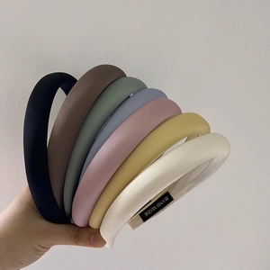 Detail of seven padded sponge headbands in matte fabric with hand made label details