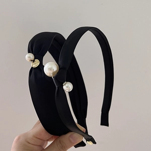 Elegant black knotted headband with white pearls and a golden handmade charm