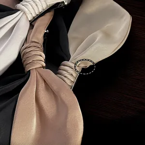 Close-up of a large French satin bow hair clip with elegant layered fabric textures