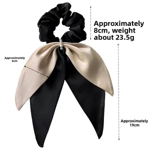 Detailed view of satin bow scrunchie with elegant pearls and luxury ribbon texture