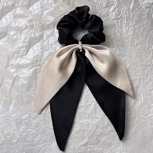 Elegant satin hair scrunchie with long ribbons and pearl accents in black and champagne