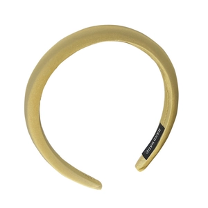 Elegant champagne gold satin padded headband with a handmade label on a white background