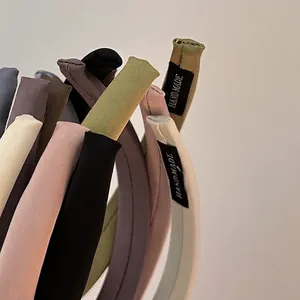 Handmade fabric sponge headbands in various colors featuring clean stitching and logo detail