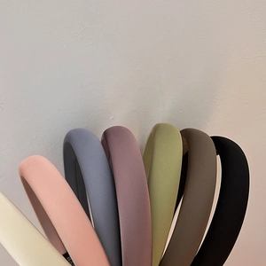 Macro shot of padded sponge headbands in various Morandi colors and matte fabric texture