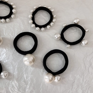 Black high-elastic hair bands featuring assorted white pearl accents on white background