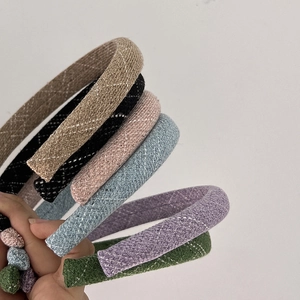 Detail view of colorful braided sponge headbands with textured woven fabric finish