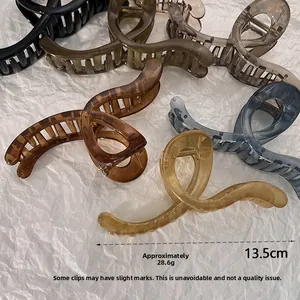 Detail showing 13.5cm large french hair claw clip with its spring and acrylic texture