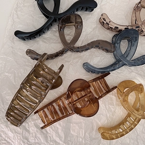 French jelly-colored shark hair clips in assorted minimalist resin colors on white background
