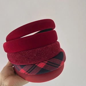 Detail showing five assorted burgundy velvet and plaid headbands with rich textures