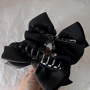 Elegant black satin bow claw clip for a French style hair bun and elegant styling