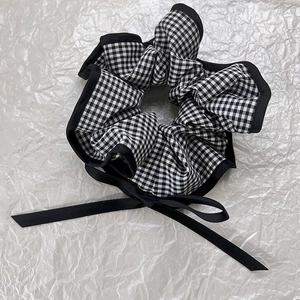French vintage black and white checkered scrunchie with long ribbon bow on white background