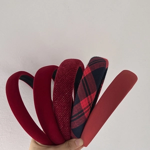 Detail view of five assorted red velvet and plaid retro headbands for women