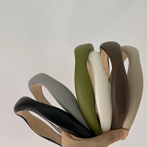 Detail showing a 6-pack of thick faux lambskin sponge headbands in various solid colors