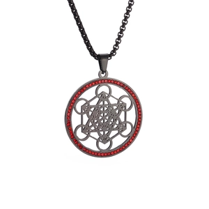 Macro detail of black stainless steel hexagram pendant with red crystal embellishments