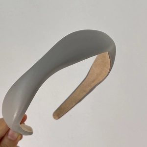 Detail of grey faux leather padded headband with soft velvet lining and thick sponge design