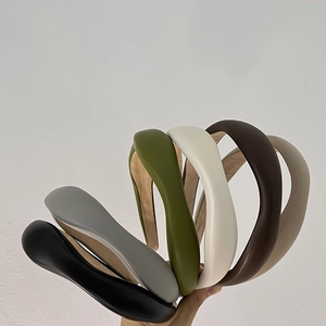 Detail showing various colors of French-style padded faux leather wavy sponge headbands
