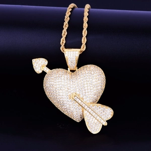 Iced out heart and arrow pendant necklace in gold finish with a classic rope chain